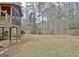 Large backyard features a flat grassy area, mature trees, and a partial view of the home's screened porch at 40 High St, Sharpsburg, GA 30277