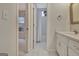 Hall bathroom with a white tiled floor leading to a bedroom with a window at 40 High St, Sharpsburg, GA 30277