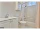 Well-lit bathroom featuring a vanity with storage, toilet, and shower-tub combination at 40 High St, Sharpsburg, GA 30277