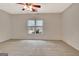 Spacious bedroom featuring neutral carpeting, ceiling fan, and a window at 40 High St, Sharpsburg, GA 30277