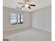 Bright bedroom featuring neutral carpet, a window, and a ceiling fan at 40 High St, Sharpsburg, GA 30277