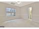 Bright bedroom featuring neutral carpet, a window, and an ensuite bathroom at 40 High St, Sharpsburg, GA 30277