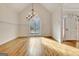 Formal dining room featuring hardwood floors, vaulted ceiling, chandelier, and a decorative window at 40 High St, Sharpsburg, GA 30277