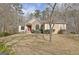 Charming home featuring a stone facade, manicured landscaping, and a welcoming red front door at 40 High St, Sharpsburg, GA 30277