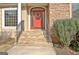 Classic entrance featuring stone stairs and a welcoming red front door at 40 High St, Sharpsburg, GA 30277