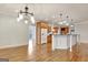 Spacious kitchen featuring wood cabinets, a center island with a countertop, and wood floors at 40 High St, Sharpsburg, GA 30277