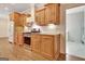 Modern kitchen with wood cabinets, granite countertops, a stainless steel stove and backsplash at 40 High St, Sharpsburg, GA 30277