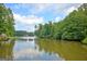 Picturesque view of a calm lake with trees, and a boat, perfect for relaxing on the water at 40 High St, Sharpsburg, GA 30277