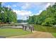 Scenic view of a lake with lush trees, a boat dock, and a boat ramp at 40 High St, Sharpsburg, GA 30277