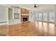 Bright living room boasts hardwood floors, a stone fireplace, built-in shelves, and large windows at 40 High St, Sharpsburg, GA 30277