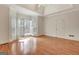 Bright main bedroom featuring hardwood floors, large bay windows with plantation shutters, and white door at 40 High St, Sharpsburg, GA 30277