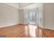 Bright main bedroom featuring hardwood floors, large bay windows with plantation shutters, and trey ceiling at 40 High St, Sharpsburg, GA 30277