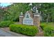 Landscaped Canongate Village community sign enhances the neighborhood's curb appeal and welcomes residents at 40 High St, Sharpsburg, GA 30277