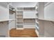 Spacious walk-in closet featuring custom shelving and hardwood floors, maximizing storage and organization at 40 High St, Sharpsburg, GA 30277