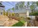 Charming backyard with stone pavers, a fire pit, and detached garage at 120 Middleton Dr, Peachtree City, GA 30269