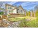 A beautiful backyard with a stone patio, tiered garden beds, and a manicured lawn at 120 Middleton Dr, Peachtree City, GA 30269