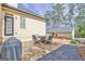 Stone patio features outdoor seating, a grill, and manicured backyard at 120 Middleton Dr, Peachtree City, GA 30269