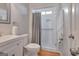 Well-lit bathroom featuring a shower, toilet, and vanity with sink, all in a bright, clean space at 120 Middleton Dr, Peachtree City, GA 30269