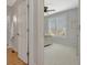 Bedroom viewed through doorway; features neutral color palette and plantation shutters at 120 Middleton Dr, Peachtree City, GA 30269