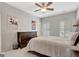 Bedroom features a queen bed, dresser, ceiling fan, and shuttered windows at 120 Middleton Dr, Peachtree City, GA 30269