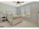 Cozy bedroom features a queen bed, side table, and bright windows with shutters at 120 Middleton Dr, Peachtree City, GA 30269