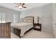 Well-lit bedroom features a queen bed, side table, and a tall mirror at 120 Middleton Dr, Peachtree City, GA 30269