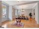 Light-filled dining room with hardwood floors and elegant chandelier at 120 Middleton Dr, Peachtree City, GA 30269