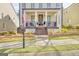 Inviting front porch with dark railing and stairs, light pillars, and manicured landscaping at 120 Middleton Dr, Peachtree City, GA 30269