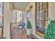 Inviting front porch with a comfortable wicker chair, a stylish potted evergreen, and a glass front door at 120 Middleton Dr, Peachtree City, GA 30269