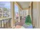 Inviting front porch with a comfortable wicker chair and a stylish potted evergreen at 120 Middleton Dr, Peachtree City, GA 30269
