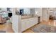 Kitchen with white cabinets, granite countertops, stainless steel appliances, with open floor plan to living spaces at 120 Middleton Dr, Peachtree City, GA 30269