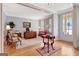 Open-concept floor plan with light gray walls, hardwood flooring, transom windows, and office area at 120 Middleton Dr, Peachtree City, GA 30269