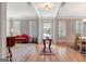 Open-concept floor plan with light gray walls, hardwood flooring, transom windows, and elegant furnishings at 120 Middleton Dr, Peachtree City, GA 30269