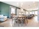 Open dining room with hardwood floors, modern lighting, and seamless flow to the kitchen at 135 Kelmscott Ln, Fayetteville, GA 30214