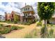 Street view of beautiful homes with manicured lawns, trees, and stone walkways on a sunny day at 135 Kelmscott Ln, Fayetteville, GA 30214