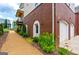 Exterior of home with brick archways and gravel path at 135 Kelmscott Ln, Fayetteville, GA 30214