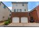 Two-car garage situated on a brick driveway at 135 Kelmscott Ln, Fayetteville, GA 30214