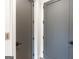 Hallway features two grey doors and white trim at 135 Kelmscott Ln, Fayetteville, GA 30214