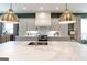 Bright, airy kitchen featuring white marble countertops, a central island, and stainless steel fixtures at 135 Kelmscott Ln, Fayetteville, GA 30214