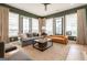 Stylish living room boasting lots of natural light, modern decor, and hardwood floors at 135 Kelmscott Ln, Fayetteville, GA 30214