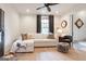 Bright living room with a comfortable white sectional sofa, stylish decor, and hardwood floors at 135 Kelmscott Ln, Fayetteville, GA 30214