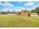 Back of a brick home with an enclosed porch and generous yard space at 229 Callaway Rd, Fayetteville, GA 30215