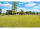 Spacious front yard with mature trees partially obscuring view of home at 229 Callaway Rd, Fayetteville, GA 30215