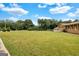 Lawn in front of a brick home with a partially obscured front entrance from mature trees at 229 Callaway Rd, Fayetteville, GA 30215