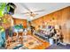 Cozy living room with wood paneling, a ceiling fan, and an inviting atmosphere at 229 Callaway Rd, Fayetteville, GA 30215