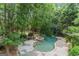 Aerial view of a backyard with pool, spa, and lush landscaping at 612 Champions Dr, Mcdonough, GA 30253