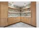 Beautiful bar area has custom wood cabinets, marble backsplash, and open shelving perfect for entertaining guests at 612 Champions Dr, Mcdonough, GA 30253