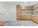 Basement kitchenette featuring custom cabinetry, shelving, and stone backsplash at 612 Champions Dr, Mcdonough, GA 30253