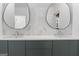 Modern bathroom featuring double vanity, two round mirrors, and sleek white countertops at 612 Champions Dr, Mcdonough, GA 30253