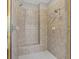Modern shower featuring tiled walls, a built-in bench, and multiple shower heads at 612 Champions Dr, Mcdonough, GA 30253